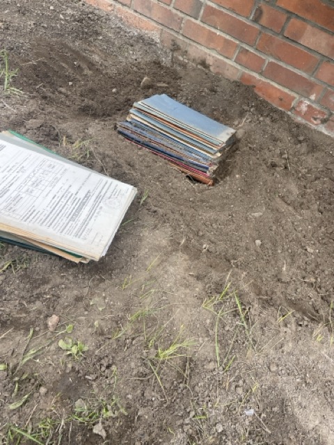 buried documents under the balcony