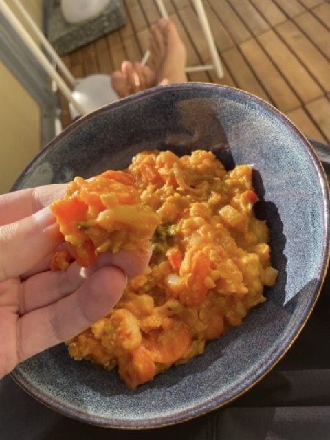 Eating lentil porridge with hands