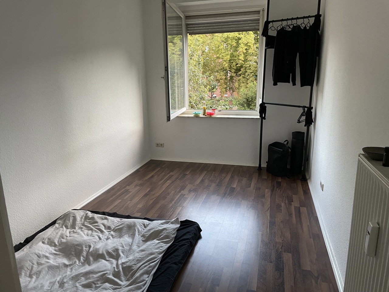 Minimalist room with telescopic wardrobe.